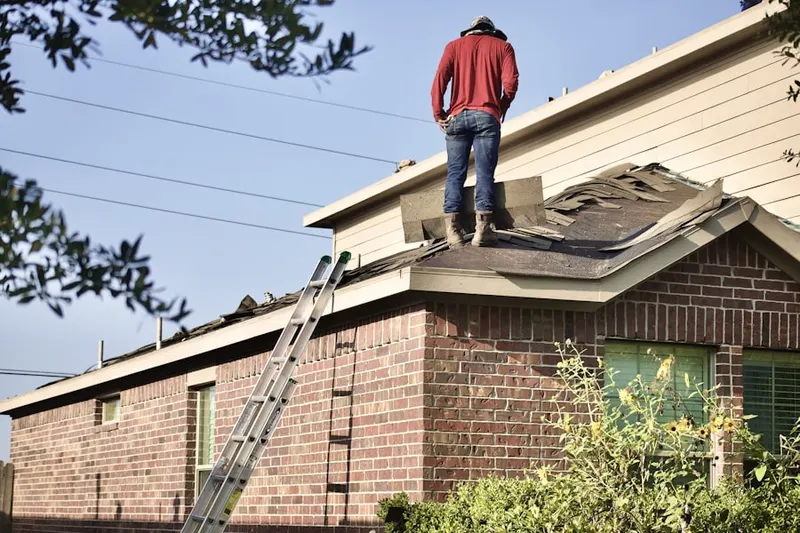 Professional roofer working on a residential roof in Richlyn Manor